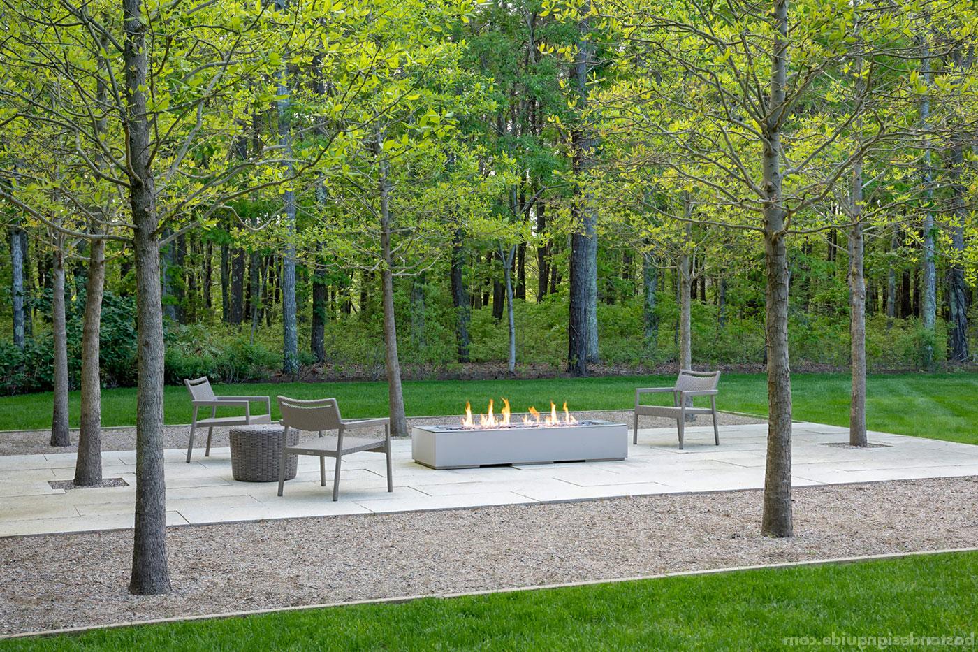 Contemporary grove-side fire feature for a Cape Cod landscape